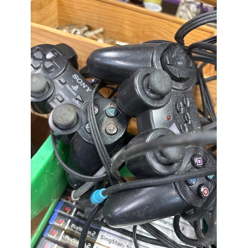 Sony PlayStation 2 console bundle with a stack of PS2 games, SingStar ...