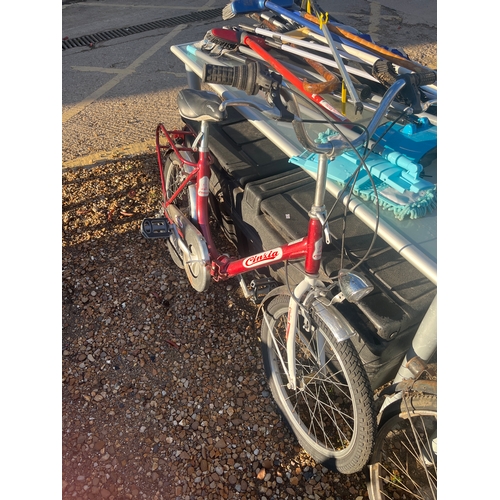 a vintage red Cicli Cinzia Firenze folding bicycle with 20-inch wheels