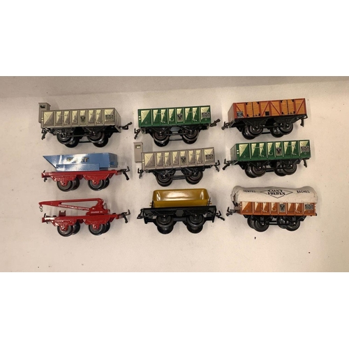 144 - Hornby for Hachette 0 Gauge tin plate rolling stock. 9 units inc. Crane, Braked open, tipper etc 
 C... 