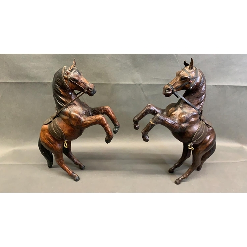 11 - A pair of vintage leather horses