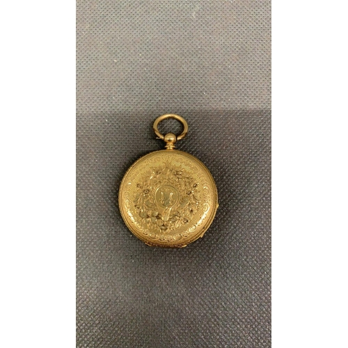 151 - An 18 carat gold ladies fob watch, with a silver face, in need of a service, presently not working. ... 