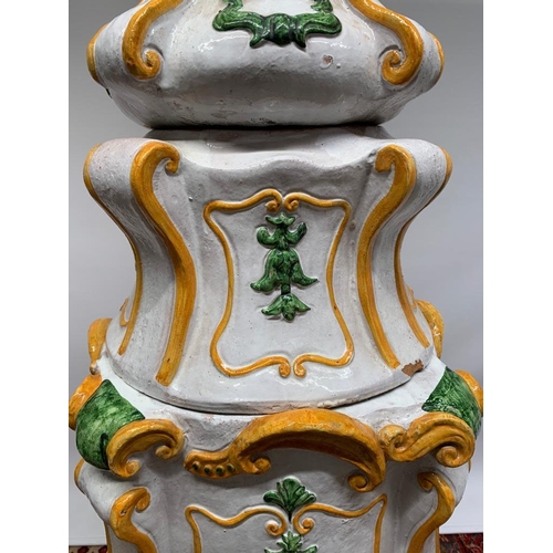 182 - A large Italian majolica terracotta parlour oven with a white, green and yellow glaze, standing 6 fe... 