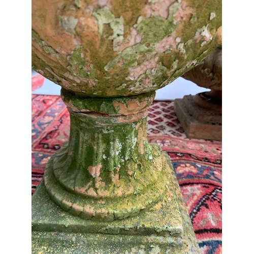 185 - A pair of weathered terracotta planters and a pair of weathered terracotta lidded urns  
  
 Planter... 