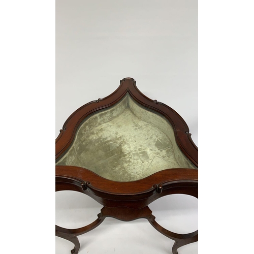 199 - An Edwardian triangular mahogany vitrine