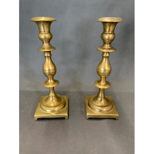 41 - A pair of solid brass antique candlesticks, 24cm high