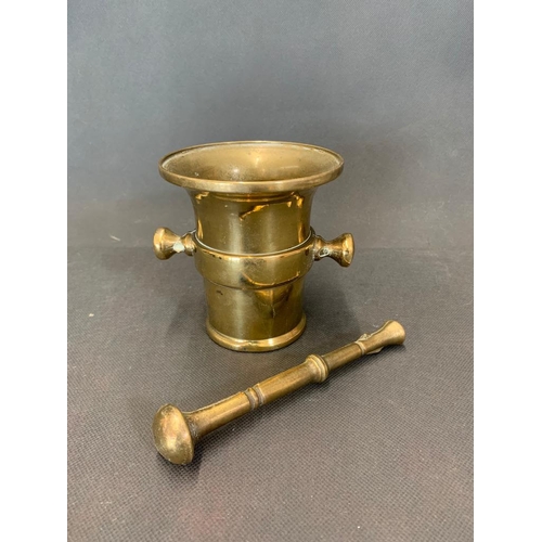 44 - A small 17th century brass pestle and mortar 10 cm high x 9 cm wide