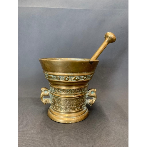 45 - A mid 17th century brass pestle and mortar marked with the letters God T Van, 14cm wide and 14cm hig... 