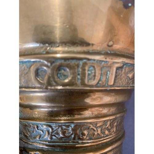 45 - A mid 17th century brass pestle and mortar marked with the letters God T Van, 14cm wide and 14cm hig... 