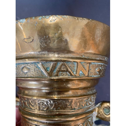 45 - A mid 17th century brass pestle and mortar marked with the letters God T Van, 14cm wide and 14cm hig... 