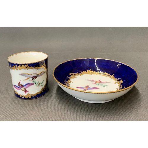 144 - A Sevres blue and gold bird design cup and saucer, date marks A and E, circa 1755-6, in beau blue? (... 