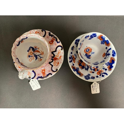 163 - Pair of well decorated cups and saucers, predominantly red and blue