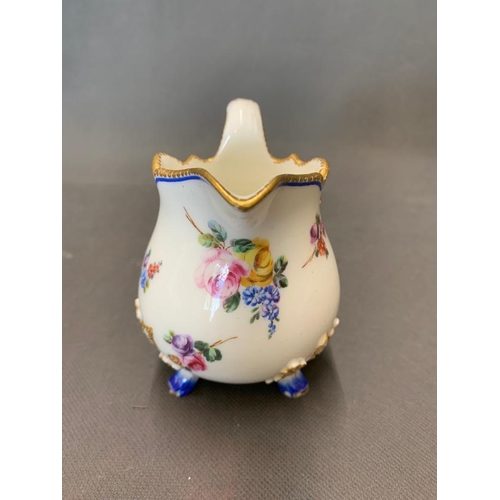 179 - An eighteenth century milk jug, with floral decoration