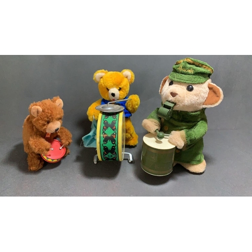 23 - A Carl original wind up bear with drum along with a vintage battery operated drumming bear and a Har... 