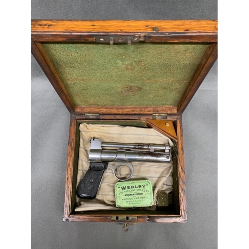 184 - A vintage Webley chrome air pistol., showing signs of plating loss 1952 made. 0.22'' bore in oak box... 