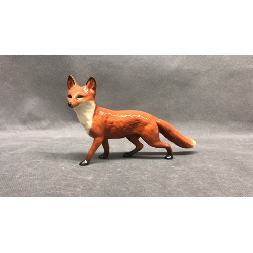 219 - A Beswick fox - on the prowl - in excellent condition, approximately 22 cm long