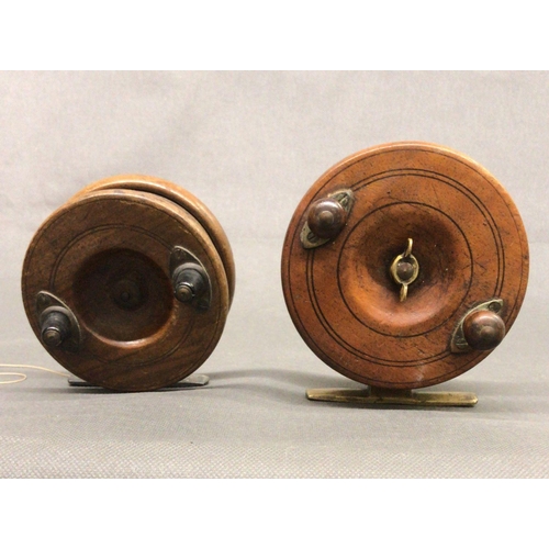 Two wooden centre pin ''Brass Strap Back'' fishing reels, one with brass  lined spool fishing reels