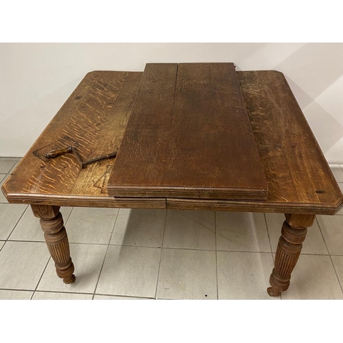 129 - A large antique oak winding extending table