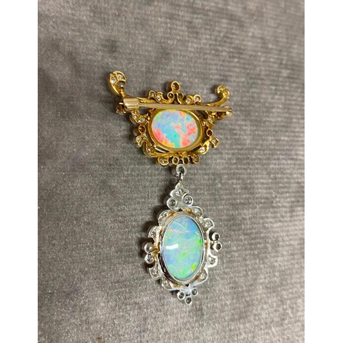 16 - A double opal brooch with diamond surround and set in 18 carat gold, possibly made in the 1920s. The... 