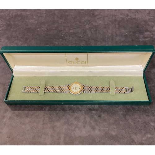 39 - A ladies Gucci watch with stainless steel and gold coloured strap £30-£50