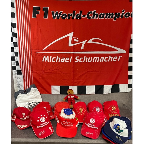 84 - 9 x Michael Schumacher caps along with 3 others including Ayrton Senna, a Schumacher flag, a teddy a... 