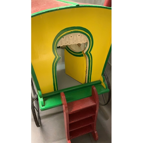 94 - A rare antique toy gypsy caravan with cast iron wheels, measures 54cm long and 53cm high