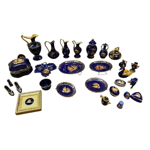 96 - A collection of 27 pieces of cobalt and gold Limoges porcelain