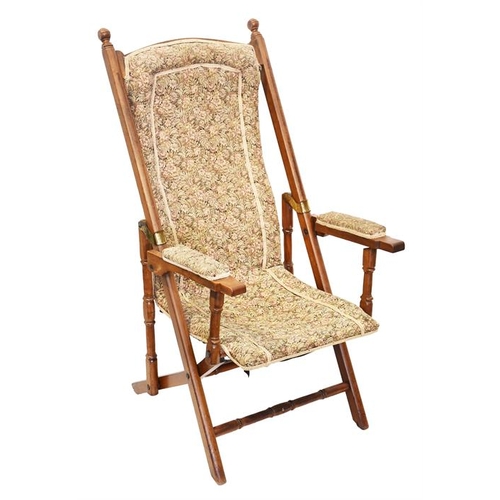 12 - A Victorian folding campaign chair
 with upholstered back, seat and arms with turned supports.