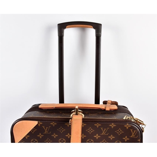 A Louis Vuitton monogrammed 55 Roll-on cabin suitcase with leather name tag  and hand strap, and gol