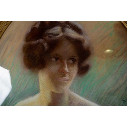 56 - Arnold Mountfort (1873-1942) British, a head and shoulders oval portrait of a woman, pastel, signed ... 