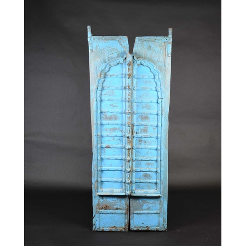 75 - A pair of North African painted wood window shutters, of rectangular form with applied arched decora... 
