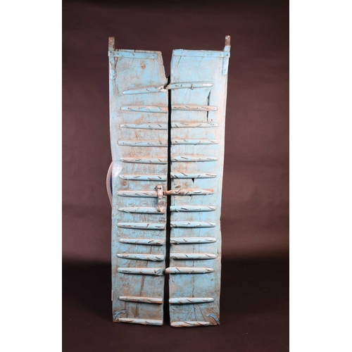 75 - A pair of North African painted wood window shutters, of rectangular form with applied arched decora... 