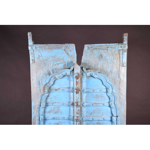 75 - A pair of North African painted wood window shutters, of rectangular form with applied arched decora... 