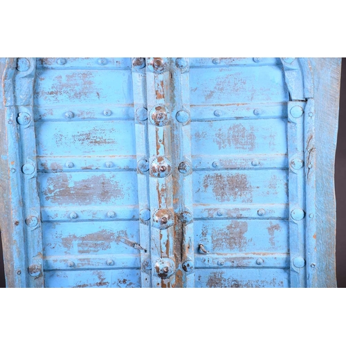 75 - A pair of North African painted wood window shutters, of rectangular form with applied arched decora... 