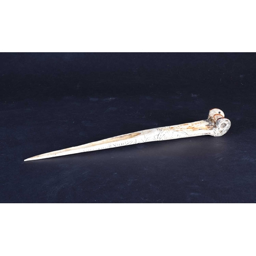 80 - A Cassowary bone dagger, East Sepik River Province, Papua New Guinea, with incised bands of stylised... 