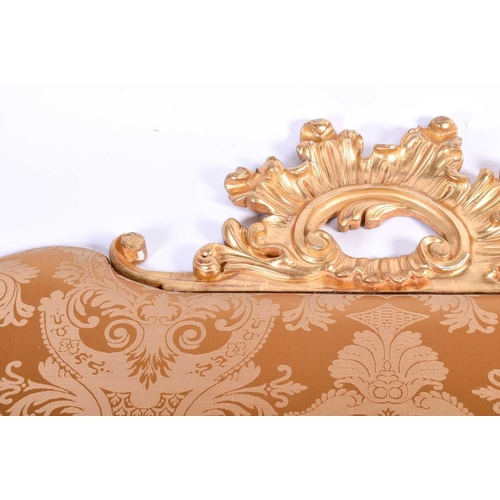 107 - A 20th century carved giltwood cushion-back headboard, with acanthus scroll surmount and corners, 21... 