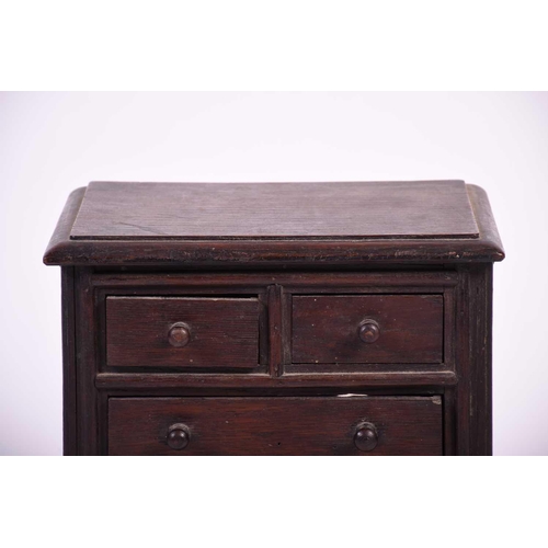 114 - A 19th century apprentice piece oak chest, the top with moulded edge above two short and three long ... 