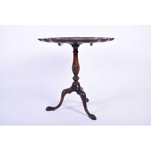 115 - An early 20th century Geo III mahogany tripod table, the shaped top with shell and scroll borders, o... 