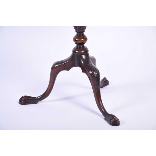 115 - An early 20th century Geo III mahogany tripod table, the shaped top with shell and scroll borders, o... 