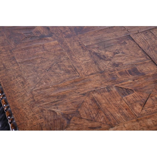 116 - An oak parquetry top table, 19th century, the square top with pronounced corners, the edge with appl... 