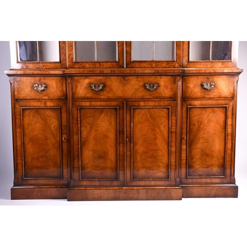 119 - A reproduction Georgian style walnut breakfront display cabinet, the glazed upper section with glass... 