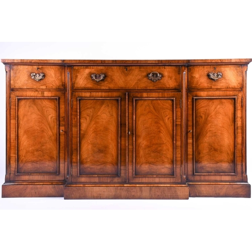 119 - A reproduction Georgian style walnut breakfront display cabinet, the glazed upper section with glass... 