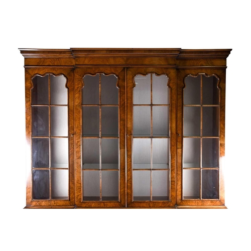 119 - A reproduction Georgian style walnut breakfront display cabinet, the glazed upper section with glass... 