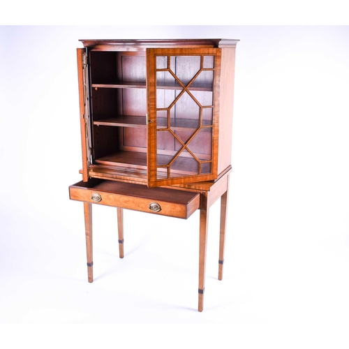 123 - A Georgian style satinwood display cabinet on stand, 20th century, the glazed doors with ebony strin... 