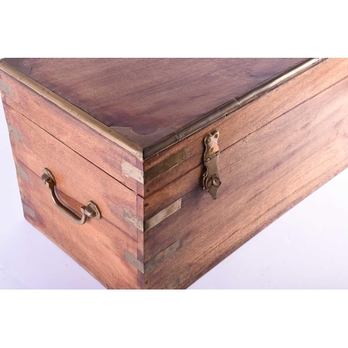 126 - A small campaign style reproduction teak chest, with brass bindings, locking clasps and carrying han... 