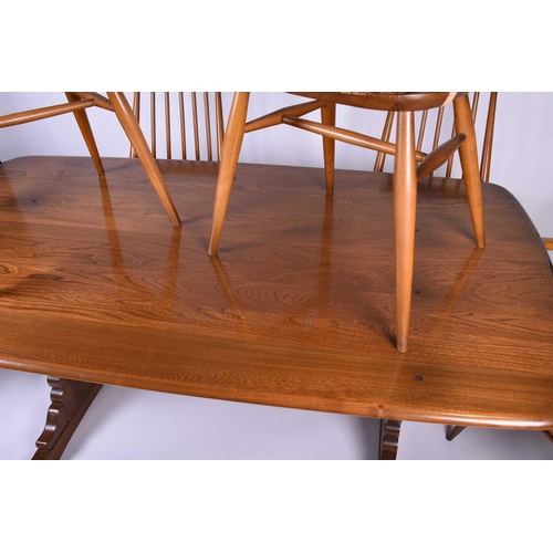 127 - Lucian Ercolani for Ercol, a mid-20th century beech dining room suite, comprising a refectory style ... 