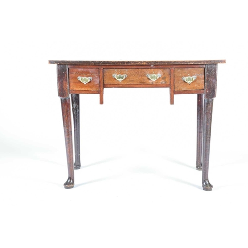 134 - A Georgian oak lowboy, 19th century, with later walnut top, above three short drawers on turned legs... 