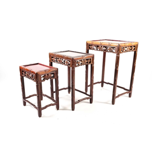 143 - A nest of three Chinese hardwood tables, early 20th century, each of rectangular form with recessed ... 