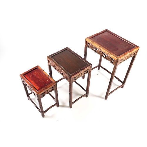 143 - A nest of three Chinese hardwood tables, early 20th century, each of rectangular form with recessed ... 