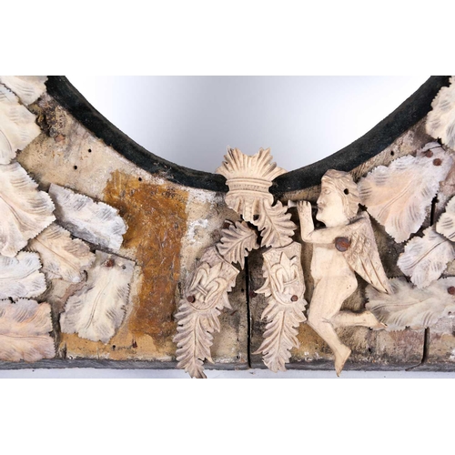 153 - A 19th century Dieppe ivory and bone mounted mirror, with applied carved bone fish and angels on a g... 