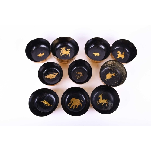 155 - A collection of Chinese black lacquered bowls, with extensive gilt decoration and animals to the int... 